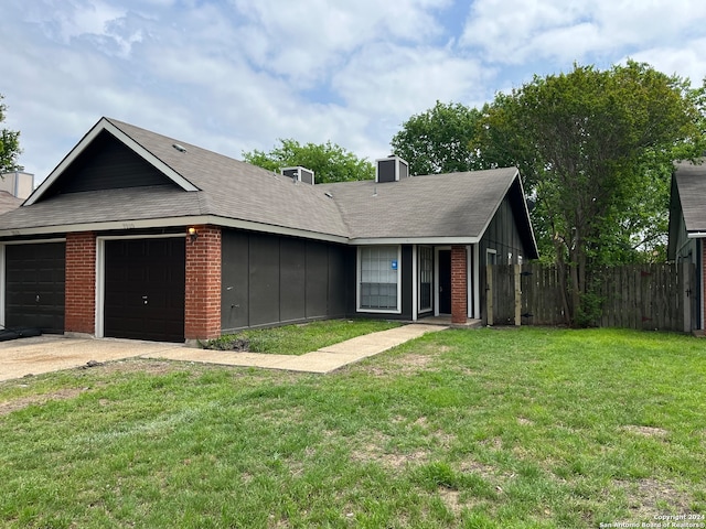 single story home with a garage and a front yard