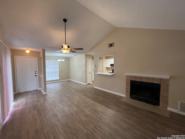 unfurnished living room with lofted ceiling, ceiling fan, dark hardwood / wood-style floors, and a fireplace