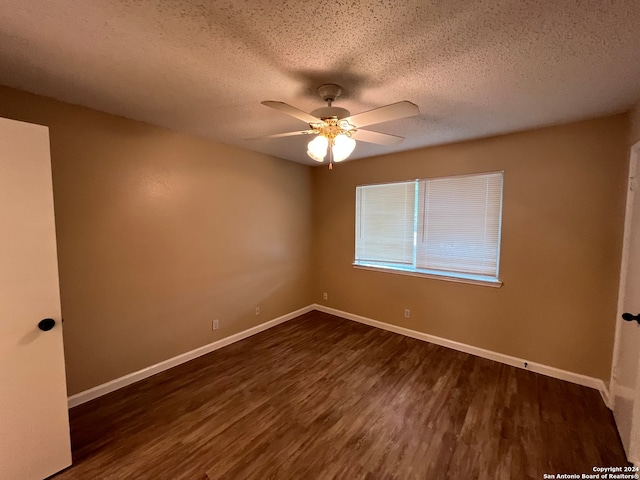 spare room with ceiling fan, dark hardwood / wood-style floors, and a textured ceiling