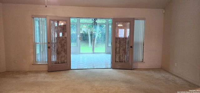 foyer entrance with carpet