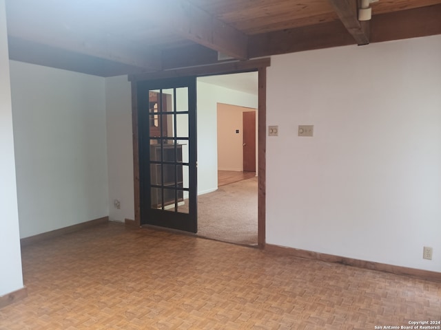 empty room featuring beam ceiling, wooden ceiling, and light parquet flooring