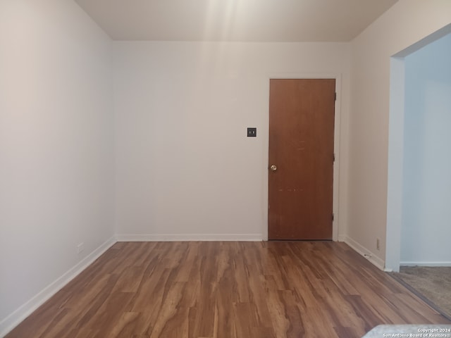 unfurnished room with hardwood / wood-style floors