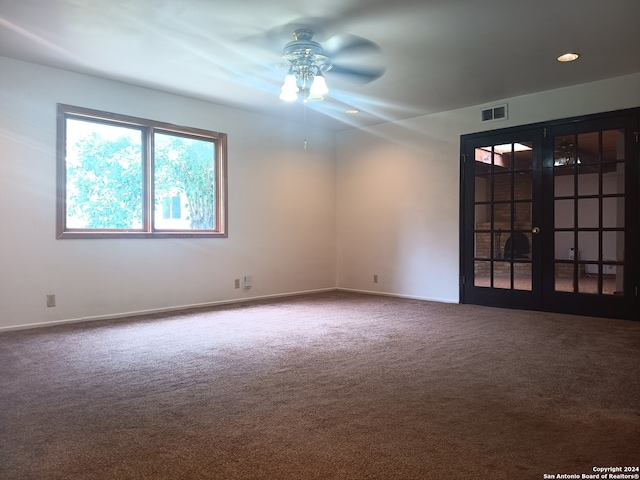 empty room with french doors, carpet flooring, and ceiling fan