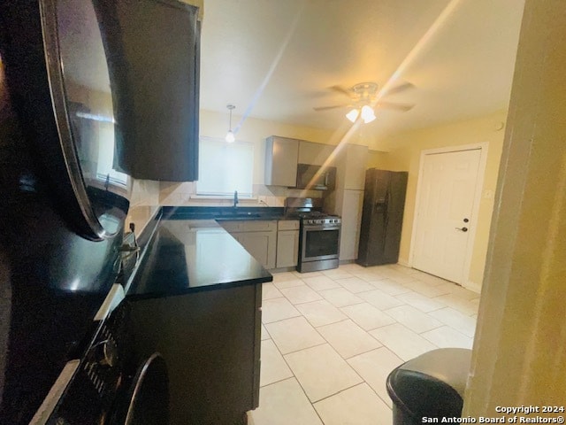 kitchen featuring ceiling fan, light tile floors, sink, gray cabinets, and stainless steel range