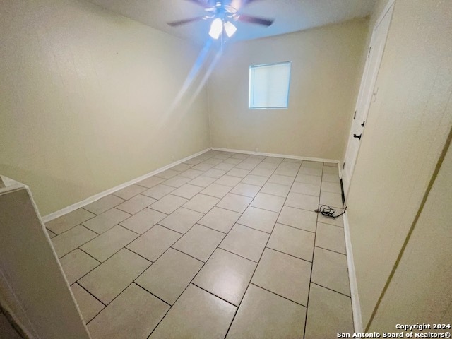 additional living space featuring ceiling fan and light tile flooring