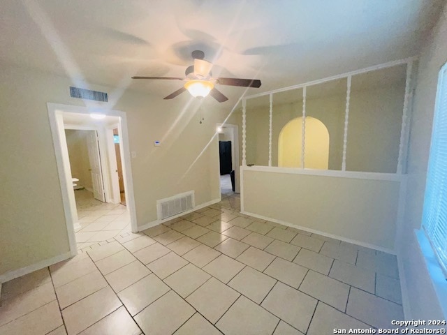 spare room featuring ceiling fan and light tile floors