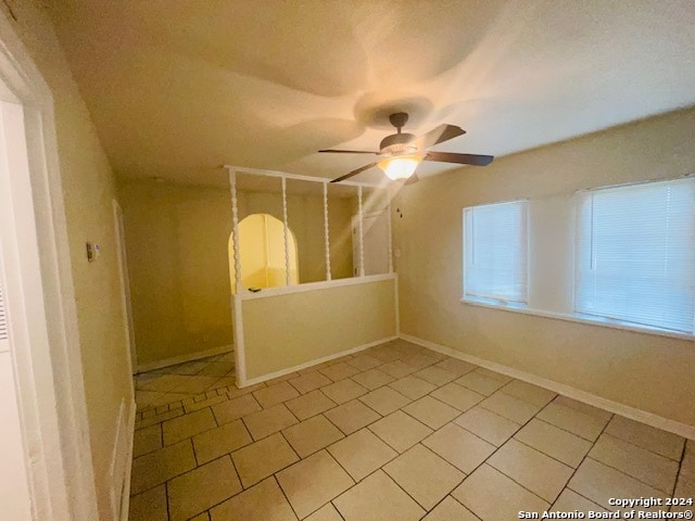 unfurnished room featuring tile flooring and ceiling fan