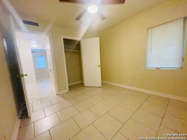 unfurnished bedroom featuring a closet, ceiling fan, and light tile floors