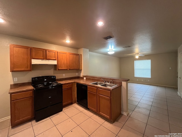 kitchen featuring kitchen peninsula, black appliances, a textured ceiling, sink, and light tile floors