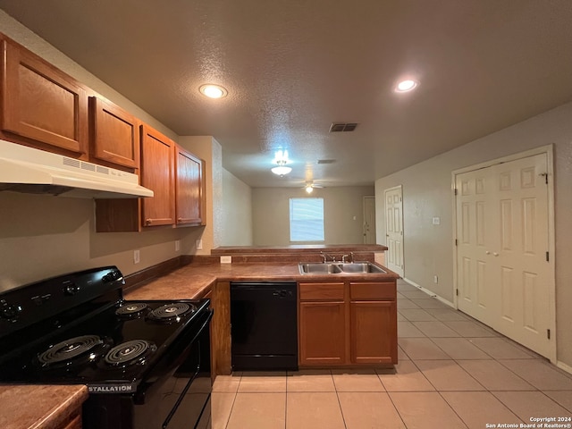 kitchen with a textured ceiling, sink, light tile flooring, black appliances, and kitchen peninsula