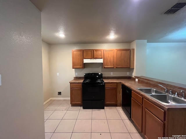 kitchen with sink, light tile floors, and black appliances