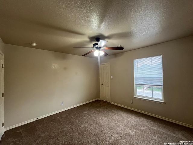 empty room with ceiling fan, carpet, and a textured ceiling