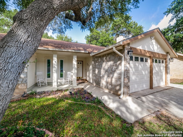 ranch-style home featuring a garage and a porch