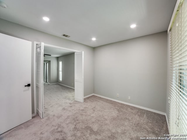 empty room featuring carpet flooring and a wealth of natural light