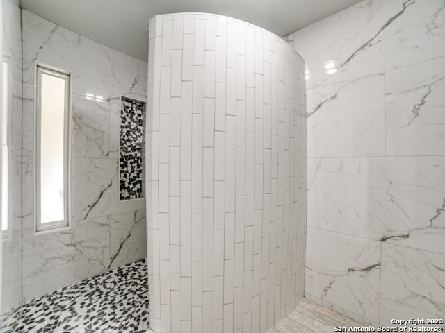 bathroom with tiled shower