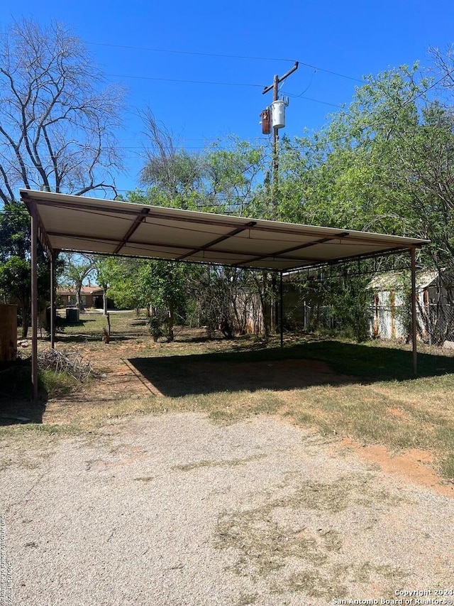 view of parking / parking lot featuring a carport