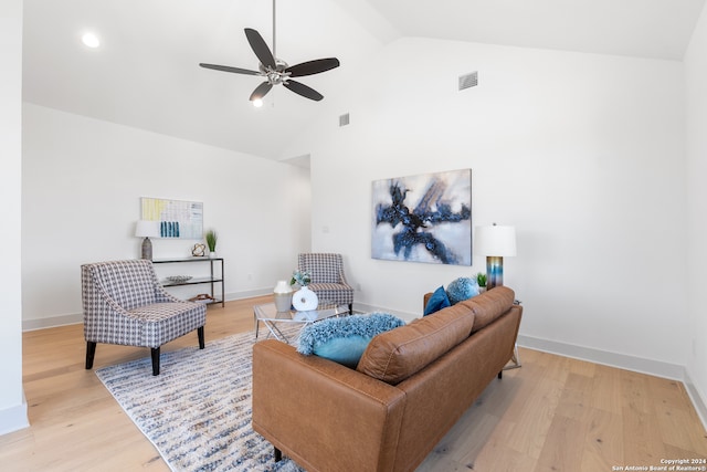 living room featuring light hardwood / wood-style flooring, high vaulted ceiling, and ceiling fan