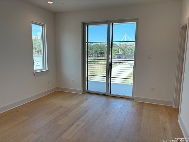 unfurnished room with light hardwood / wood-style floors