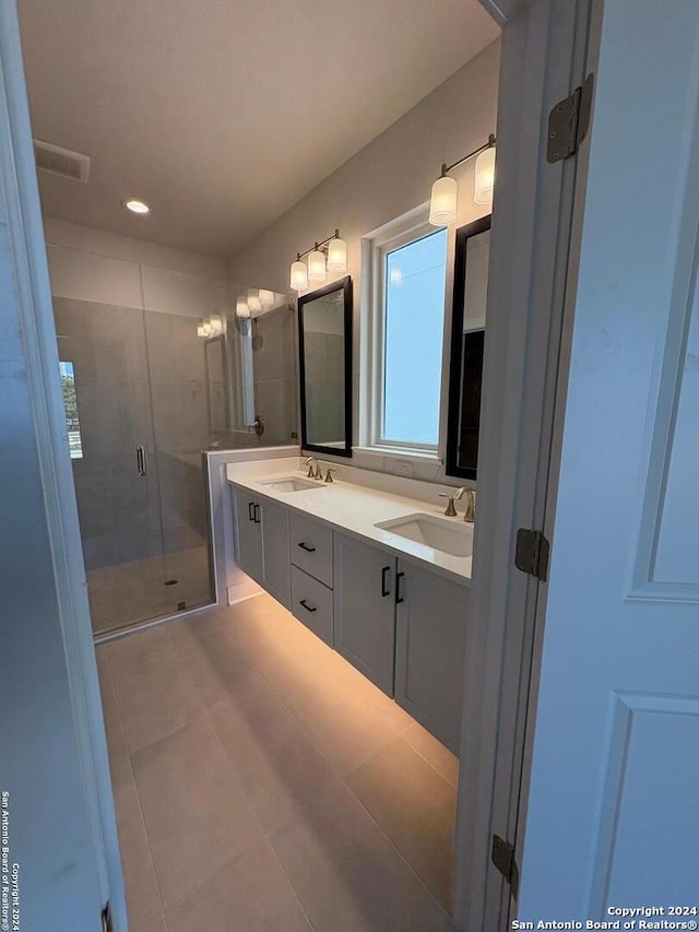 bathroom with vanity, tile patterned floors, and an enclosed shower