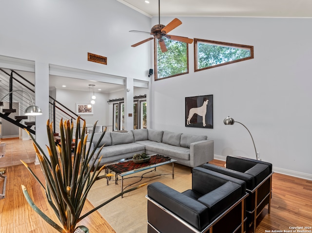 living room with high vaulted ceiling, light hardwood / wood-style flooring, and ceiling fan