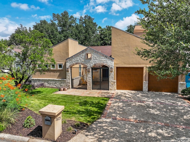 view of front of home with a garage and a front lawn