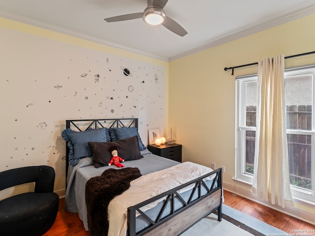 bedroom featuring wood-type flooring, ornamental molding, and ceiling fan