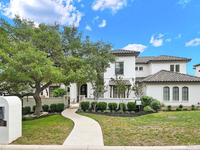 mediterranean / spanish-style home featuring a front lawn