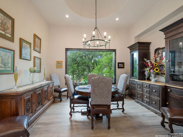 dining area featuring light hardwood / wood-style floors and an inviting chandelier