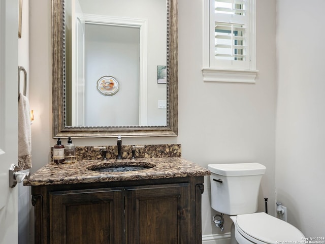 bathroom featuring toilet and oversized vanity