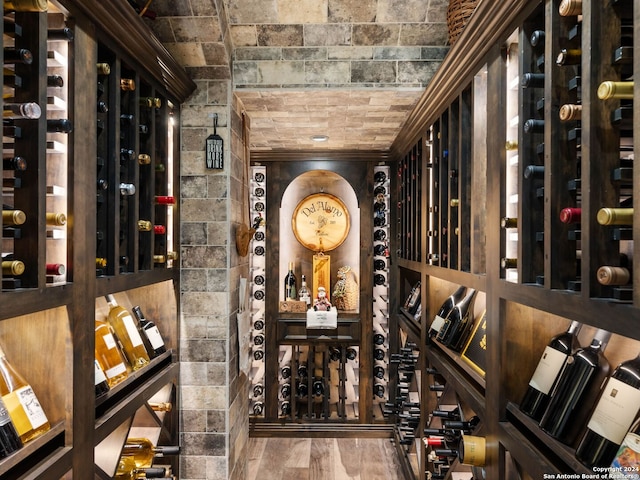 wine cellar with hardwood / wood-style floors and brick ceiling