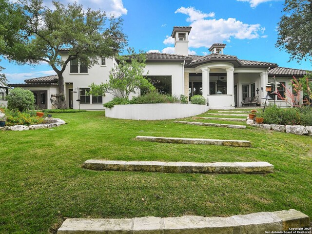 rear view of house featuring a yard