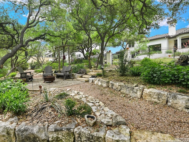 view of yard with a fire pit and a patio