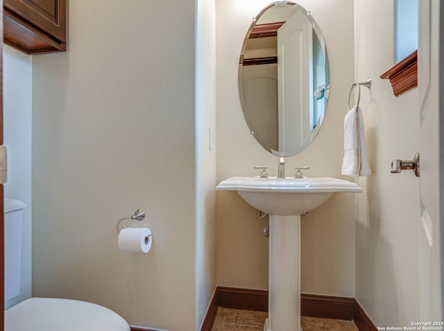 bathroom featuring toilet and tile flooring