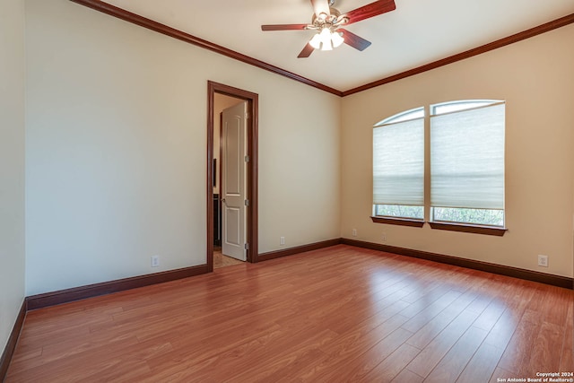 empty room with ceiling fan, hardwood / wood-style flooring, and ornamental molding