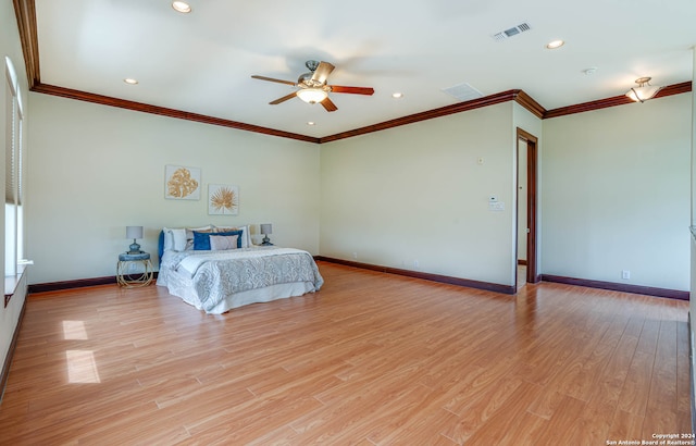 unfurnished bedroom with ceiling fan, crown molding, and light wood-type flooring