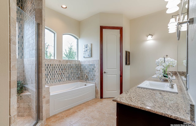 bathroom featuring vanity, tile floors, and plus walk in shower