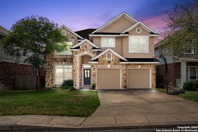 view of front of property with a yard and a garage