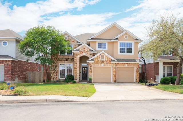 view of front of property featuring a front yard and a garage