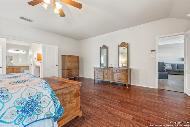 bedroom featuring ensuite bath, ceiling fan, dark hardwood / wood-style flooring, and lofted ceiling