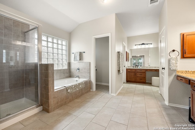 bathroom featuring tile flooring, lofted ceiling, shower with separate bathtub, and large vanity