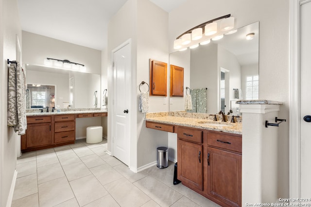 bathroom featuring double vanity and tile flooring