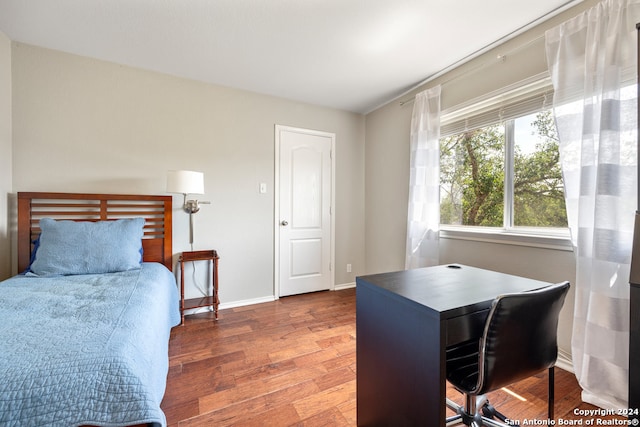 bedroom featuring dark wood-type flooring