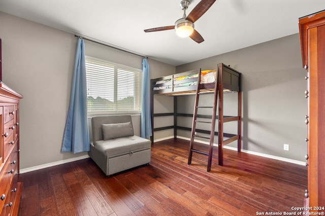 unfurnished bedroom with dark wood-type flooring and ceiling fan