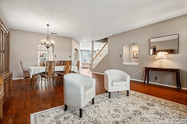 sitting room featuring an inviting chandelier and hardwood / wood-style flooring