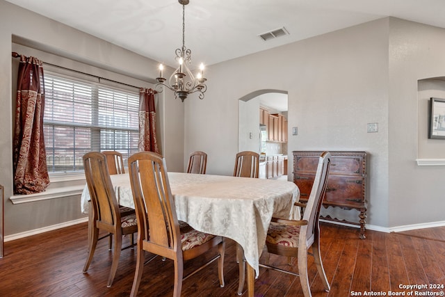 dining room featuring dark hardwood / wood-style flooring and an inviting chandelier