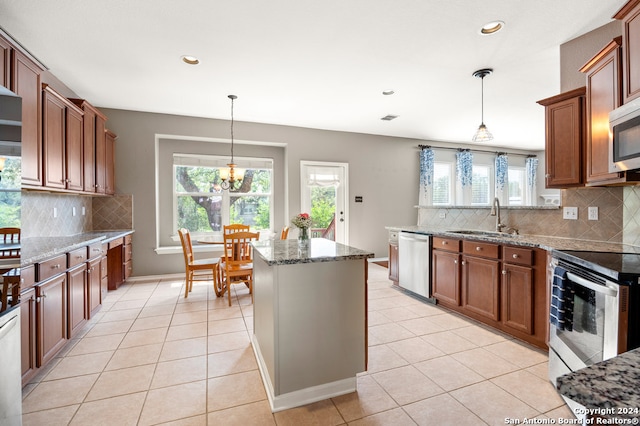 kitchen featuring sink, appliances with stainless steel finishes, a healthy amount of sunlight, and tasteful backsplash