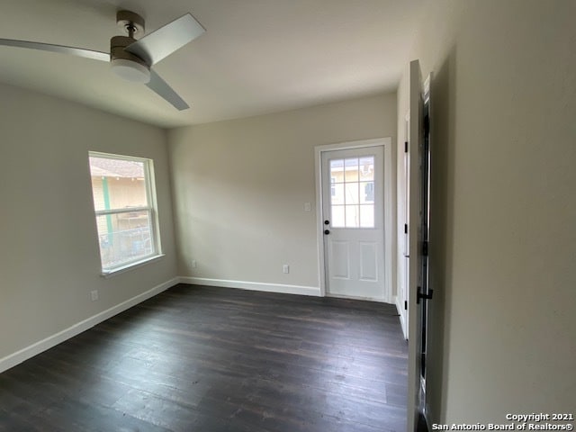 interior space with ceiling fan and dark hardwood / wood-style floors