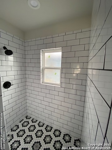 bathroom with tiled shower