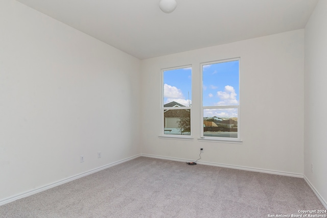 spare room with light colored carpet