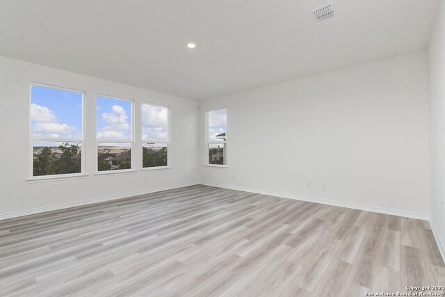 unfurnished room featuring light hardwood / wood-style floors